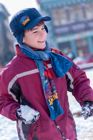 Timisoara, Romania - January 30, 2014: Kids playing with snow in the street. Real people.のeditorial素材