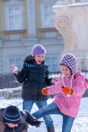 Timisoara, Romania - January 30, 2014: Kids playing with snow in the street. Real people.のeditorial素材