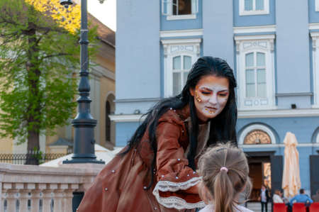 Timisoara, Romania - March 31, 2017: Woman in a masquerade costume, posing as a living statue at the CheckArt carnavalのeditorial素材