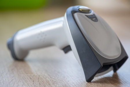 Close-up of a handheld scanner on a wooden tableの写真素材