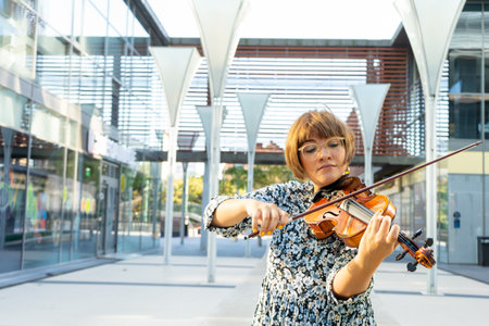 Portrait of a woman playing her violin. Musical intruments.の写真素材