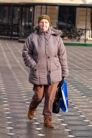 Timisoara, Romania - January 21, 2015: Woman walking on the street. Real people.のeditorial素材