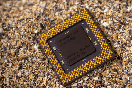 Timisoara, Romania - October 17, 2020: Close-up of a Cyrix IBM 6x86 P150+ 6x86-2V2P150GE processor, 120 Mhz, socket 7 with sand in the background.のeditorial素材