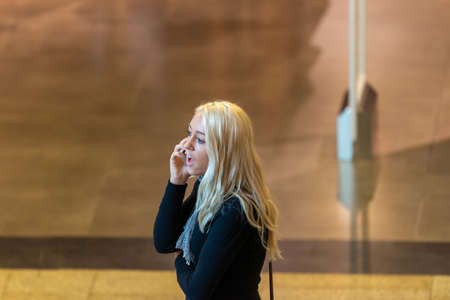 Timisoara, Romania - November 24, 2013: Woman talking on the phone. Real people.のeditorial素材