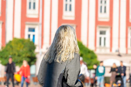 Woman walking on the street. Real people.