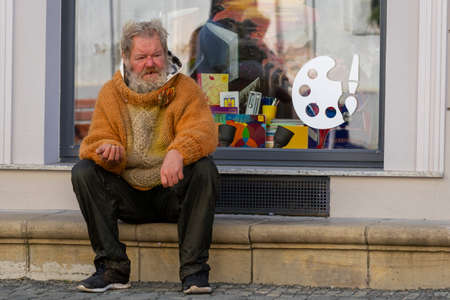 Timisoara, Romania - September 25, 2021: Homeless man sitting in the street. Real people.のeditorial素材