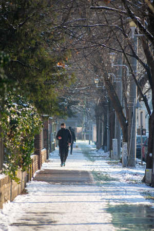 Timisoara, Romania - January 18, 2021: Man walking on the street. Real people.のeditorial素材