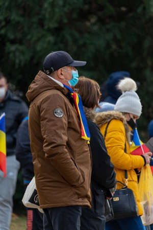 Timisoara, Romania - December 01, 2021: A man with a scarf flag at the National Day of Romania paradeのeditorial素材