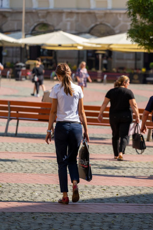 Woman walking on the street. Real people.の写真素材