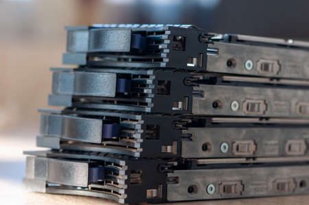Close-up of a 2.5'' HDD server caddy tray stacked on each other on a tableの写真素材
