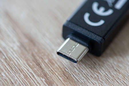 Close-up on an USB cable on a wooden tableの写真素材