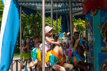 Timisoara, Romania - September 27, 2014: Young girl enjoying a ride on the Merry Go Aroundのeditorial素材
