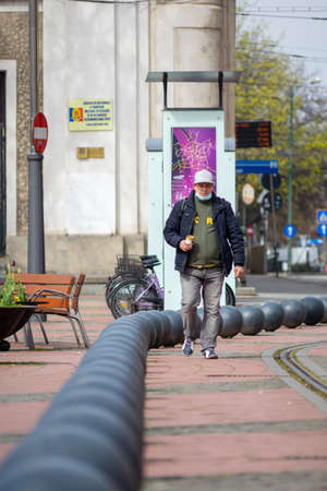Timisoara, Romania - April 17, 2021: Man walking on the street. Real people.