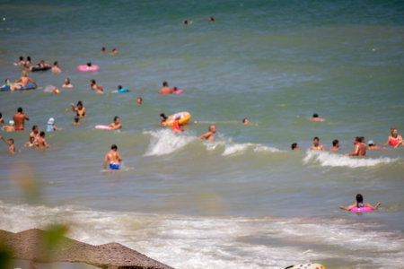 People on the beach having fun in the water. Blurred background.の写真素材