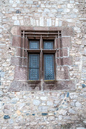 Beautiful design of a small window of a castleの写真素材