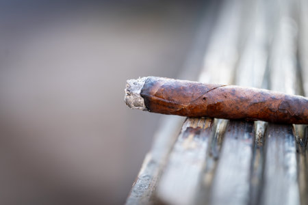 Close-up of a cigar sitting on a wooden benchの写真素材