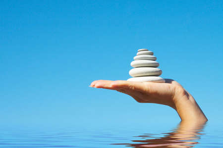  Stones in a hand on a background of the dark blue sky