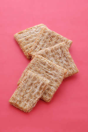 Some crackers on a red background.の写真素材