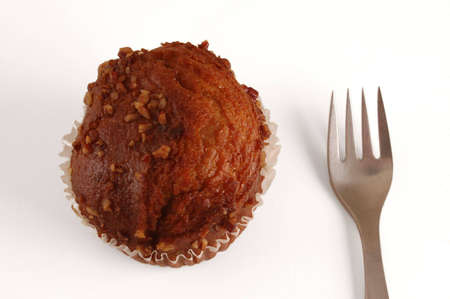 A muffin on white, with forkの写真素材