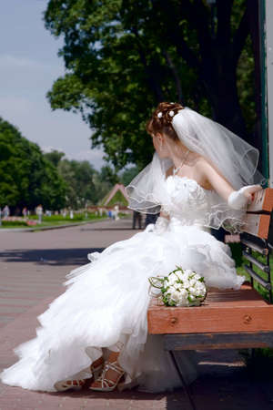 Young beautiful woman with the bouquet of white rosesの写真素材