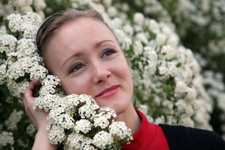 young woman with white flowersの写真素材