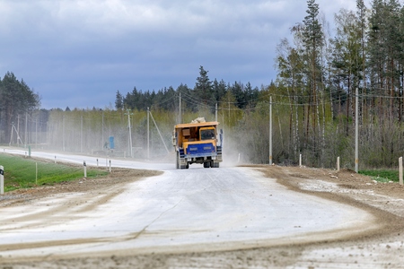 Large-yellow quarry dump trucks produce transportation of mineralsの写真素材