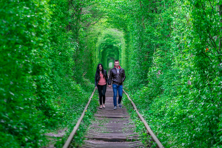The guy with the girl gudlyayut railroad tunnel of love spring forestのeditorial素材