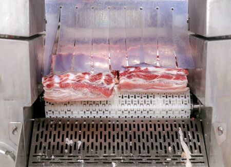 cutting beef at a meat factory.