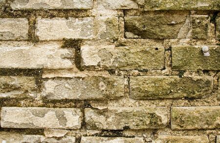 Closeup mossy brick wall