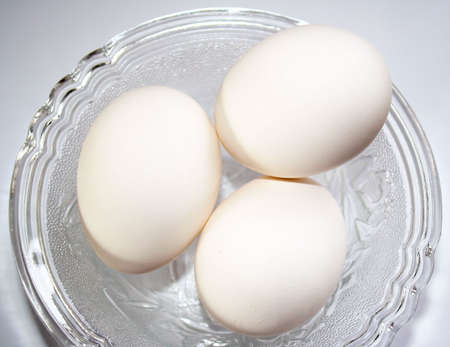 Three eggs in a dish - ready for cookingの写真素材