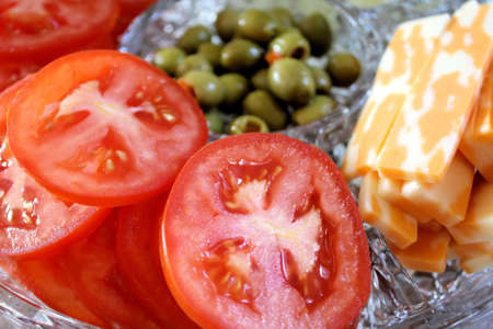 Tomato slices, cheese and green olives - garnish trayの写真素材