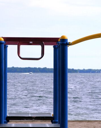 Playground equipment at the beach - boating passing byの写真素材