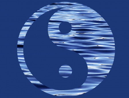 Yin Yang symbol created from beautiful rippling water isolated on a dark blue の写真素材