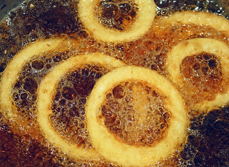 Onion Rings cooking in hot bubbly oil in a deep fryerの写真素材