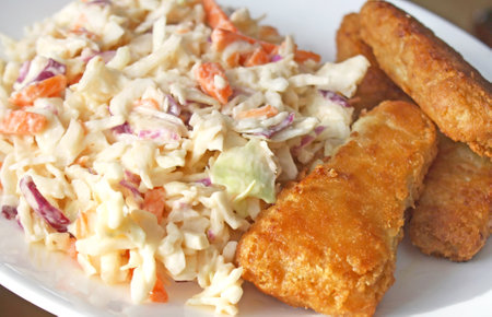 Battered Fish golden and crispy with a side of creamy homemade coleslawの写真素材