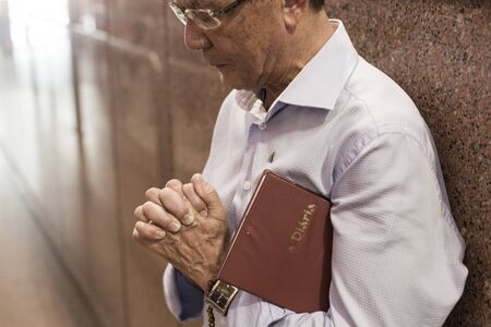 Aparecida, SÃ£o Paulo, Brazil - January 13, 2016: Faithful man prays at Cathedral of Nossa Senhora...