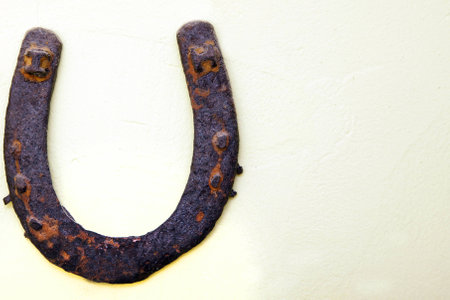 vintage rusted horseshoe on wall above doorの写真素材