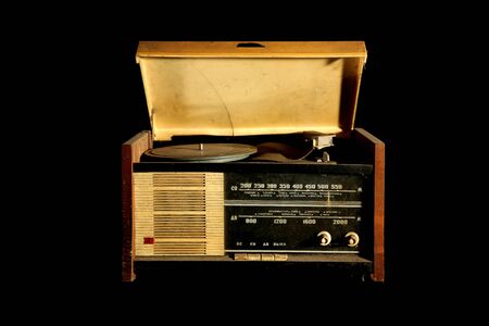 vintage radio and vinyl disc music player isolated on black backgroundの写真素材