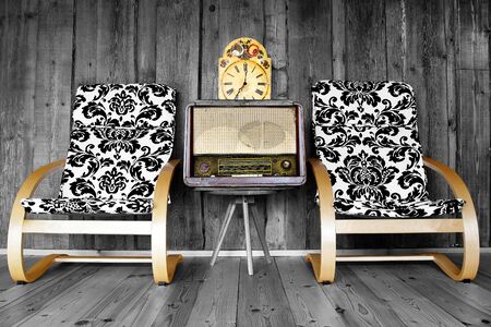 Vintage chairs with retro radio and clock on wooden の写真素材