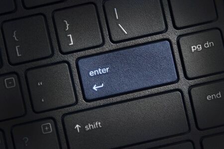 laptop computer keyboard with highlighted enter key buttonの写真素材