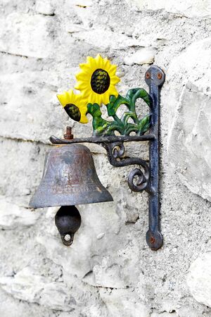 vintage italian doorbell with clapper on ancient villa wallの写真素材