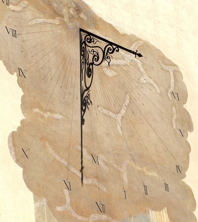 ancient sundial on wall of medieval building