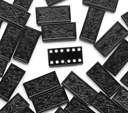 one vintage most valuable domino leader standing out crowd of other dominoes isolated on whiteの写真素材