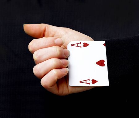 an ace up your sleeve on black background showing heartsの写真素材