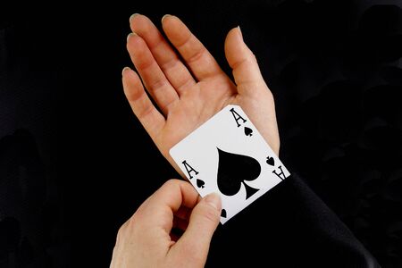 an ace up your sleeve on black background showingの写真素材