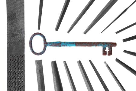 group of vintage metal files teamwork making big key on white background