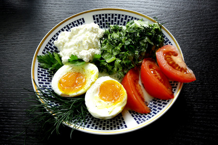 classic ethnic vegetarian breakfast with boiled eggs salad dills  curd and tomatoesの写真素材
