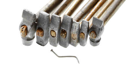 too many cooks spoil the broth proverb batch of hammers damaged nail isolated on white backgroundの写真素材