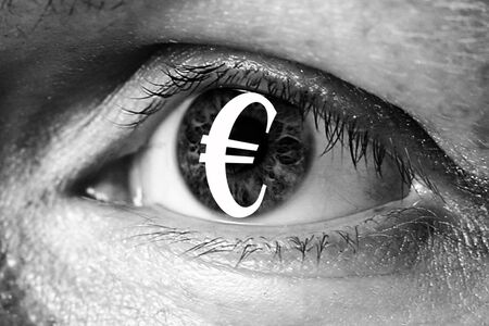 euro money sign in big eye extreme greed illegal immigrant closeupの写真素材