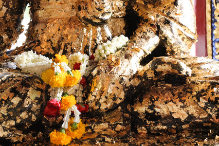 Statue with garland in the templeの写真素材
